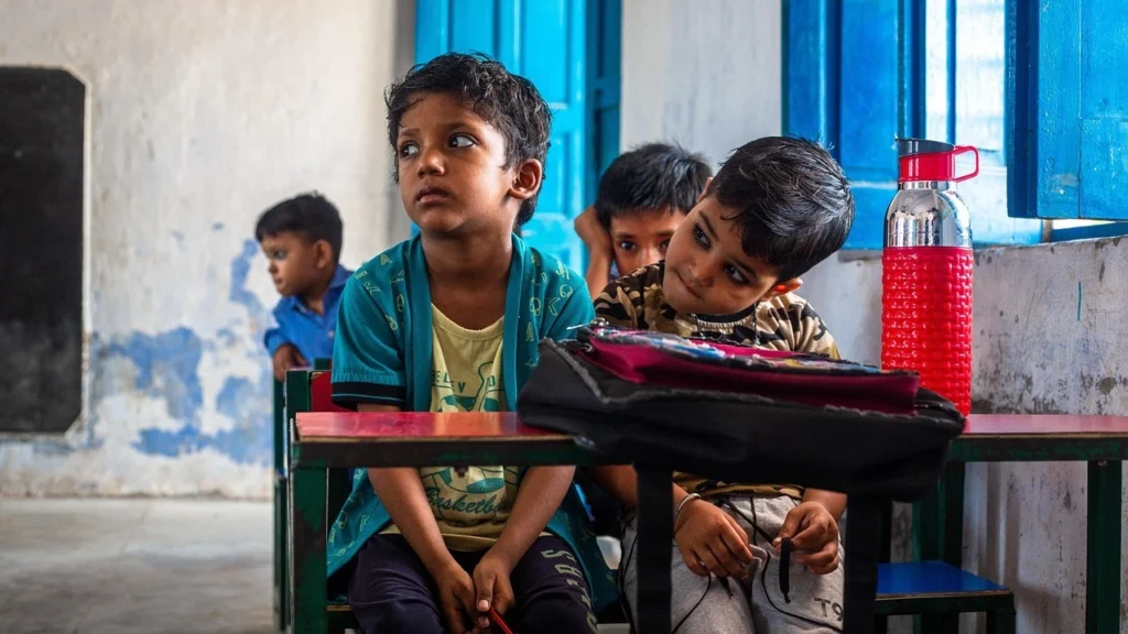 Young students sitting in a classroom representing the ground reality of the Indian education system for Pralhad Joshi.